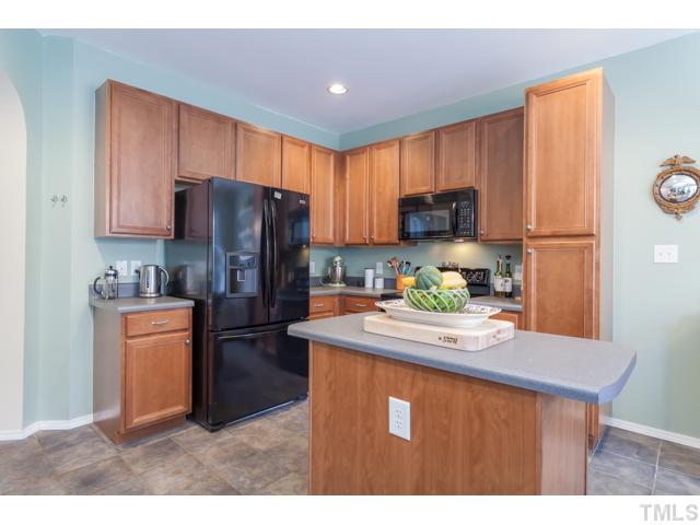 8321 Rubblestone Path Raleigh, NC 27613 - Photo 6 of 25 a kitchen with refrigerator and a stove