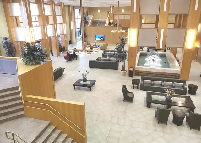 a living room filled with furniture and a floor to ceiling window