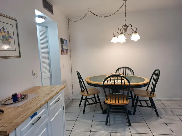 a view of a dining room with furniture and chandelier