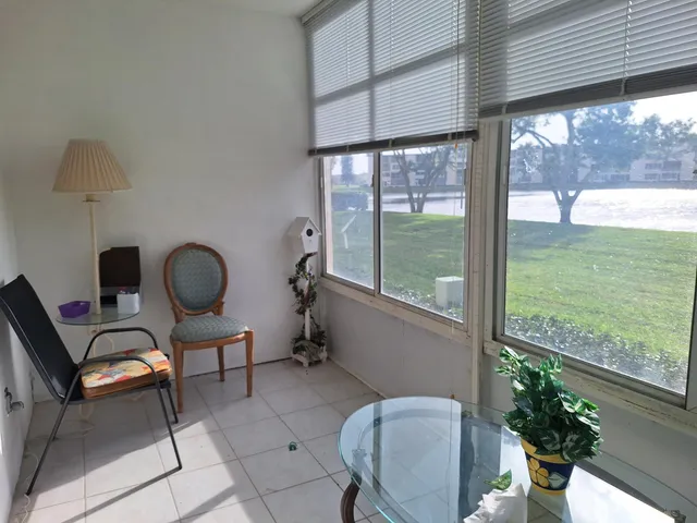 a view of a porch with chairs and backyard
