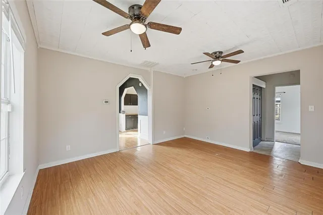 wooden floor in an empty room with a window