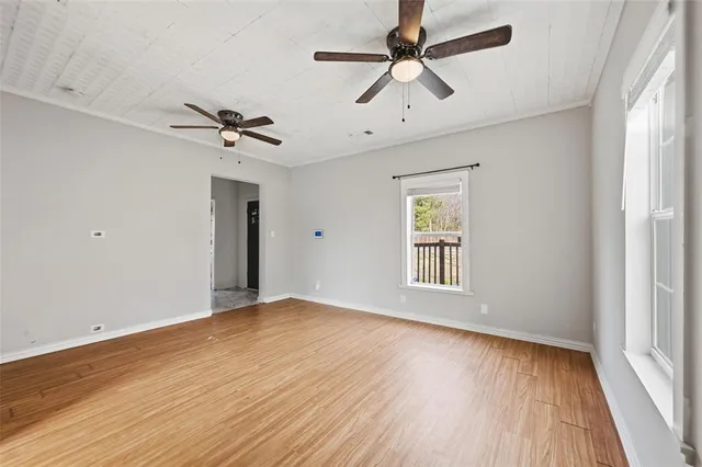 wooden floor in an empty room with a window