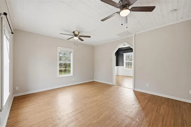 wooden floor in an empty room with a window