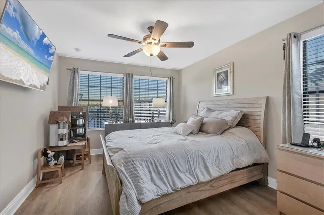 a bedroom with a bed a bookshelf and a chandelier