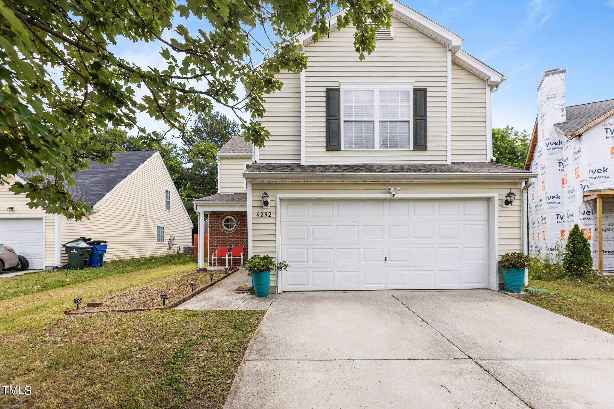 a view of a house with a yard and garage