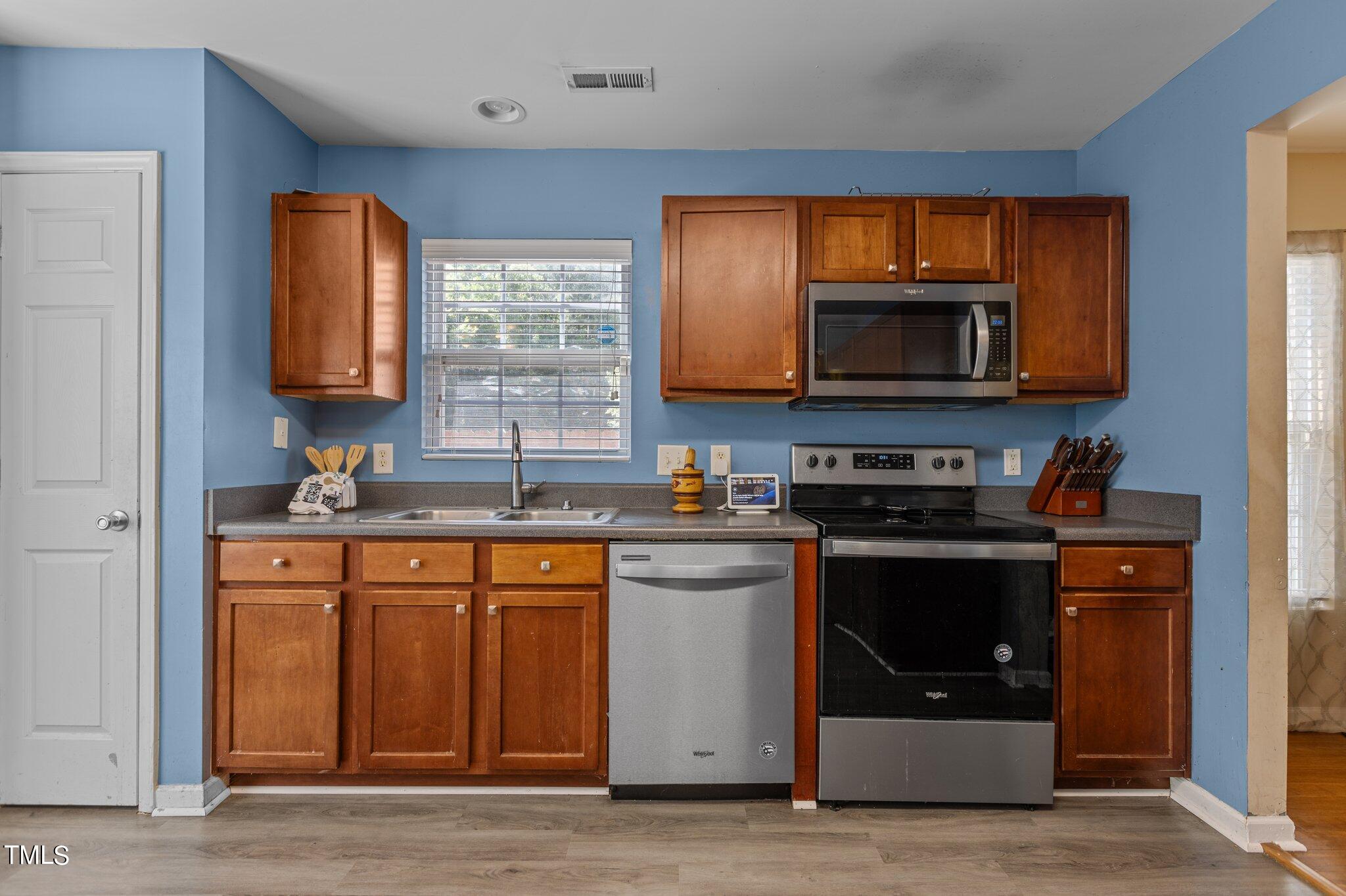 4232 Dalcross Road Raleigh, NC 27610 - Photo 15 of 38 a kitchen with a stove microwave and sink