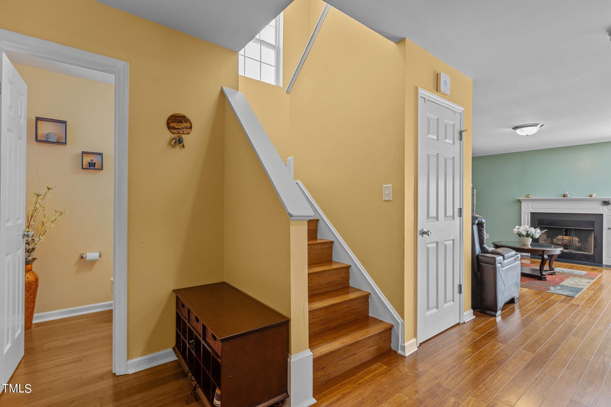 4232 Dalcross Road Raleigh, NC 27610 - Photo 16 of 38 a view of a hallway with wooden floor and staircase