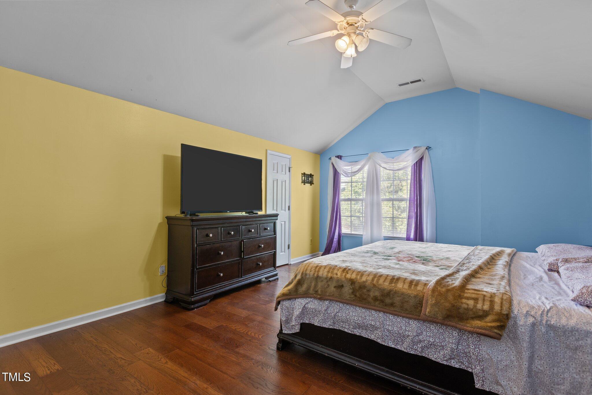4232 Dalcross Road Raleigh, NC 27610 - Photo 19 of 38 a bedroom with a bed and a flat screen tv