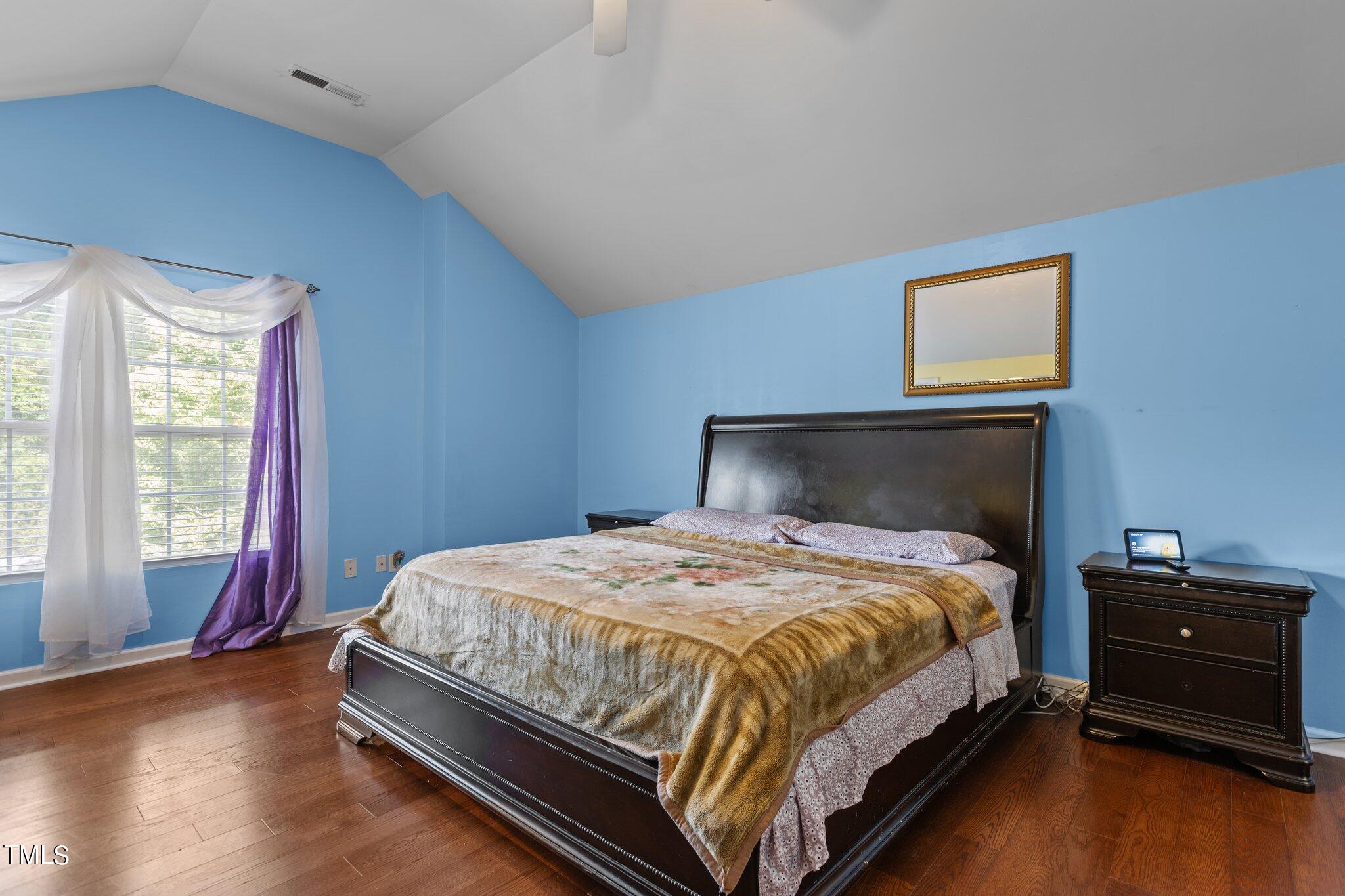 4232 Dalcross Road Raleigh, NC 27610 - Photo 20 of 38 a bedroom with a bed and wooden floor