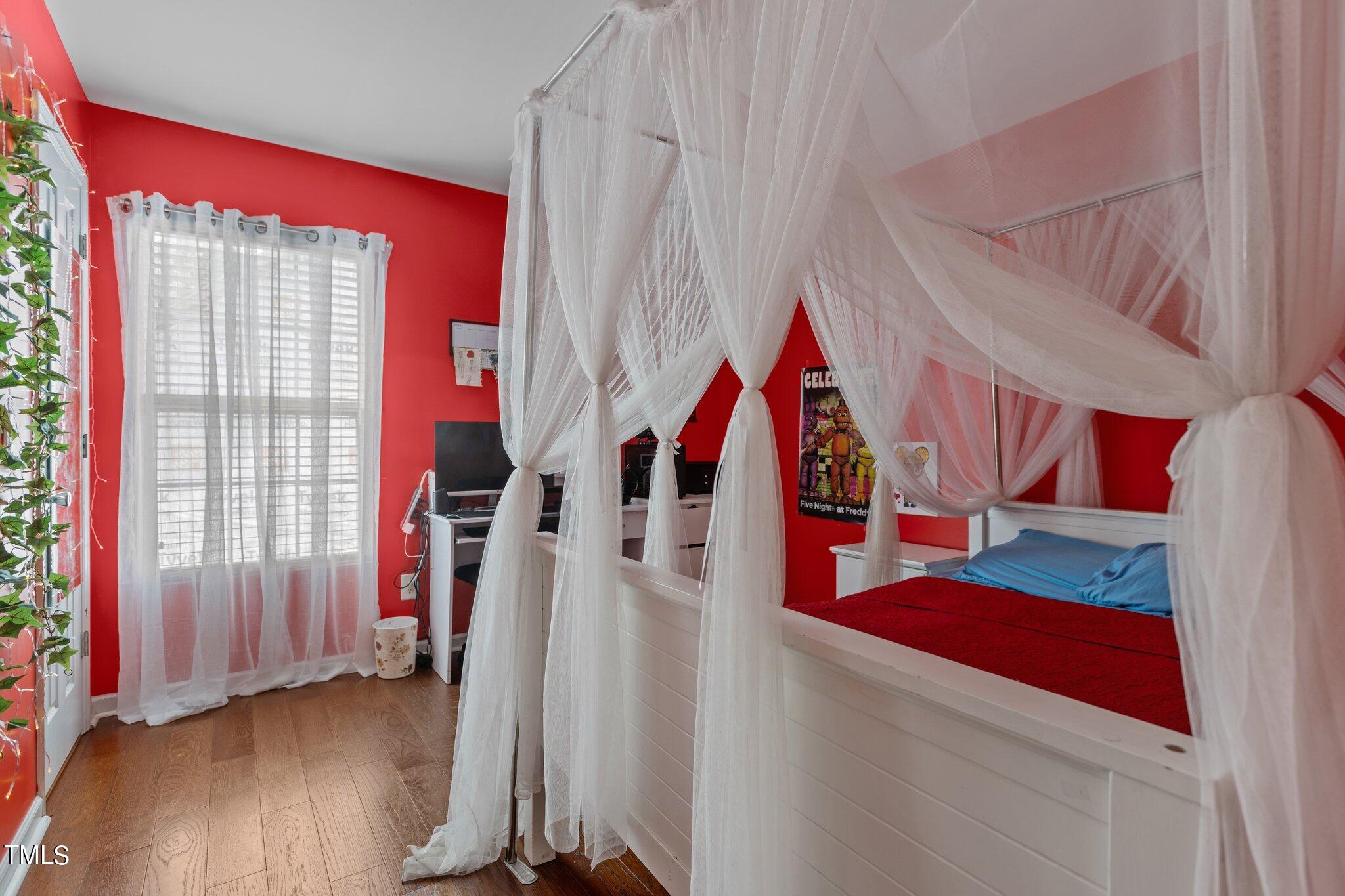 4232 Dalcross Road Raleigh, NC 27610 - Photo 24 of 38 a view of a bedroom with wooden floor and windows