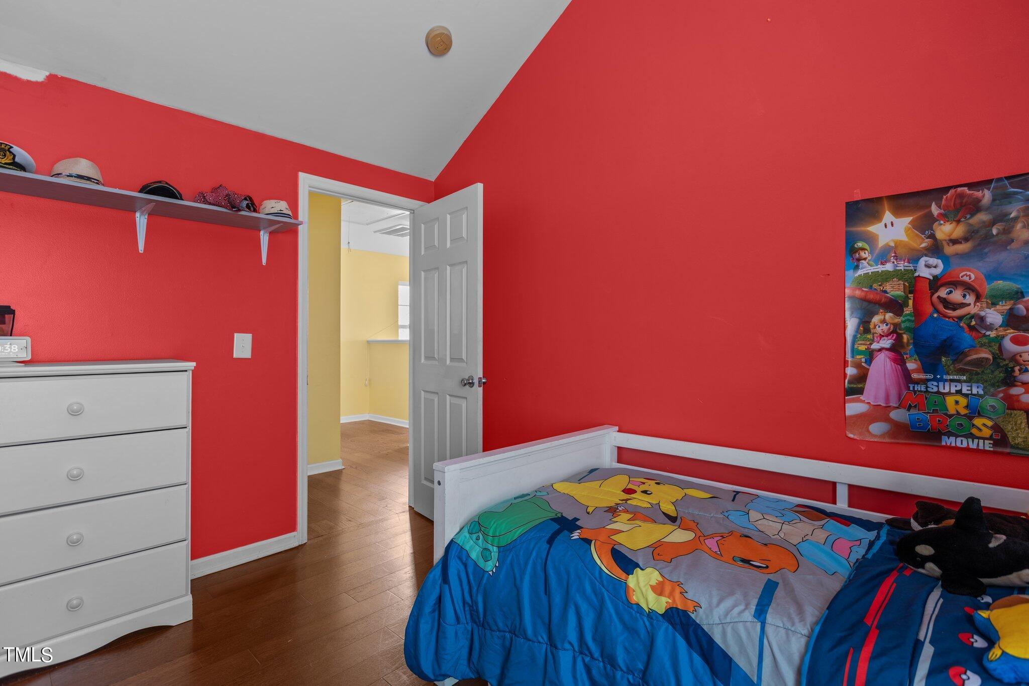 4232 Dalcross Road Raleigh, NC 27610 - Photo 27 of 38 a bed room with a bed and a book shelf