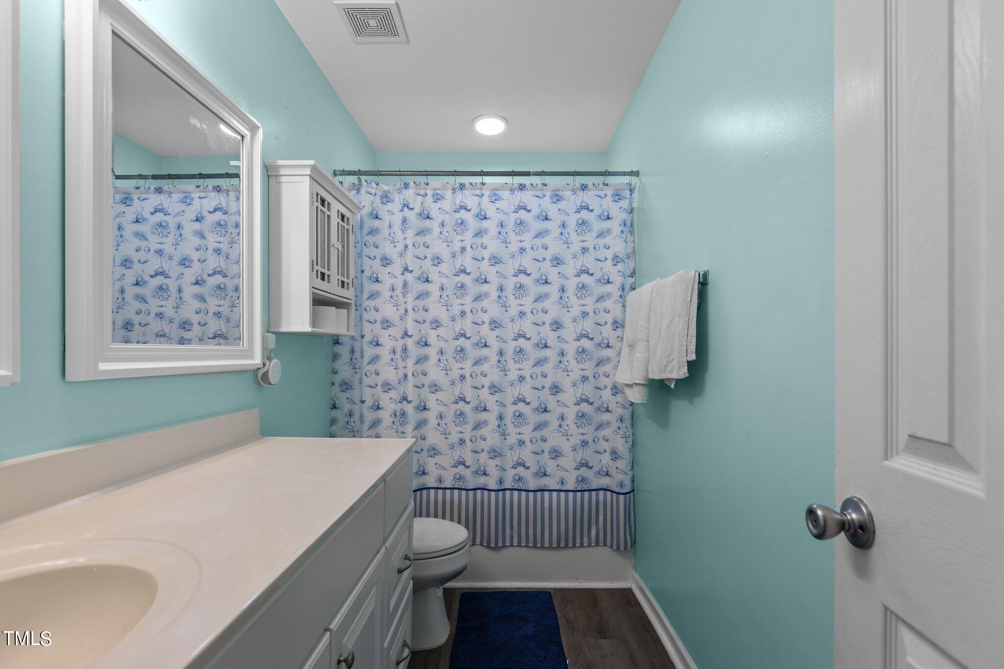4232 Dalcross Road Raleigh, NC 27610 - Photo 28 of 38 a bathroom with a sink toilet and shower