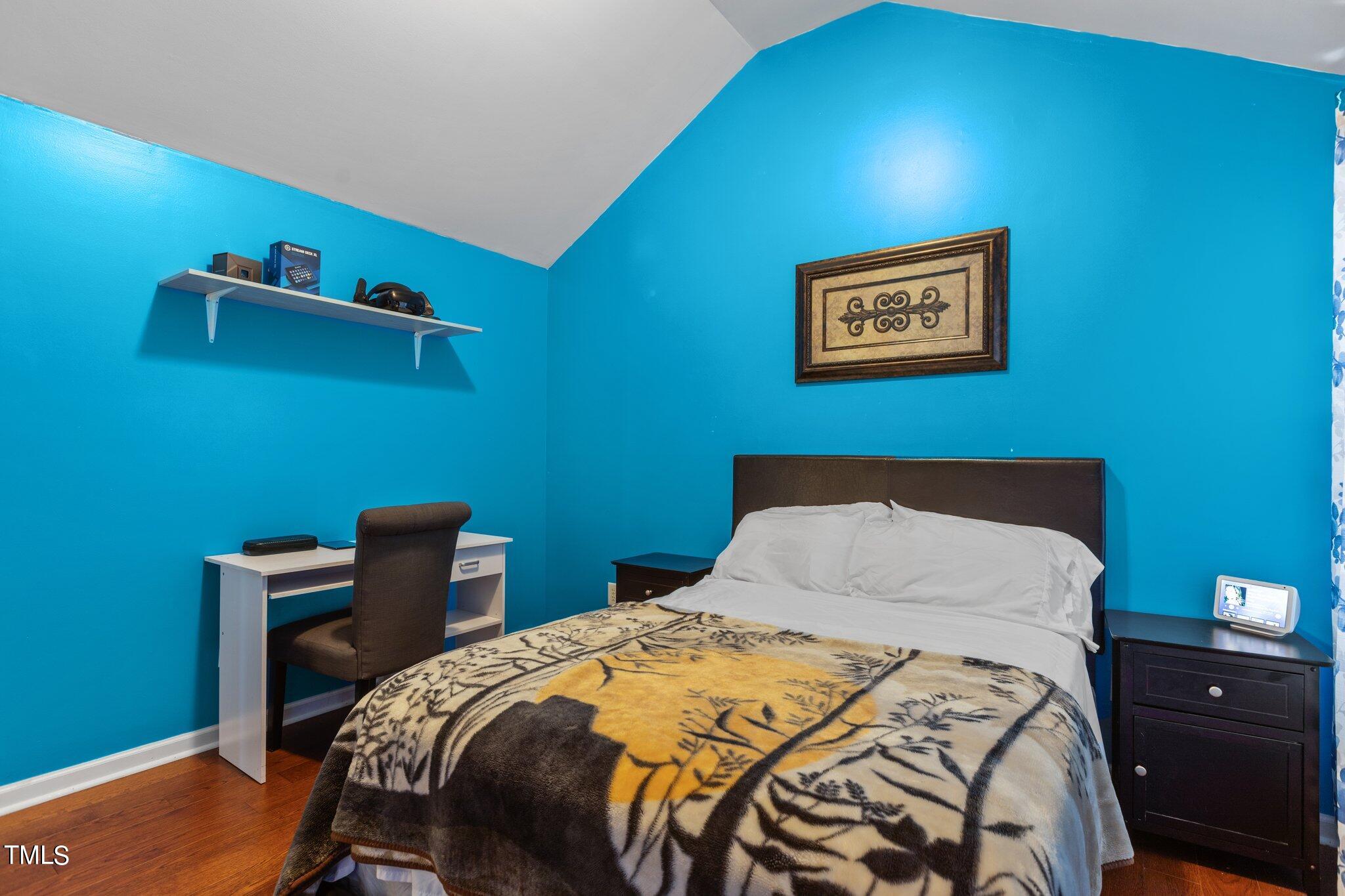 4232 Dalcross Road Raleigh, NC 27610 - Photo 30 of 38 a bedroom with a bed and a table in it