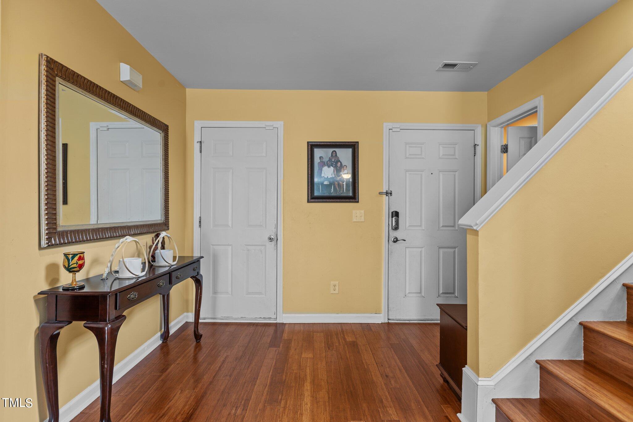 4232 Dalcross Road Raleigh, NC 27610 - Photo 3 of 38 a view of a hallway with furniture and wooden floor