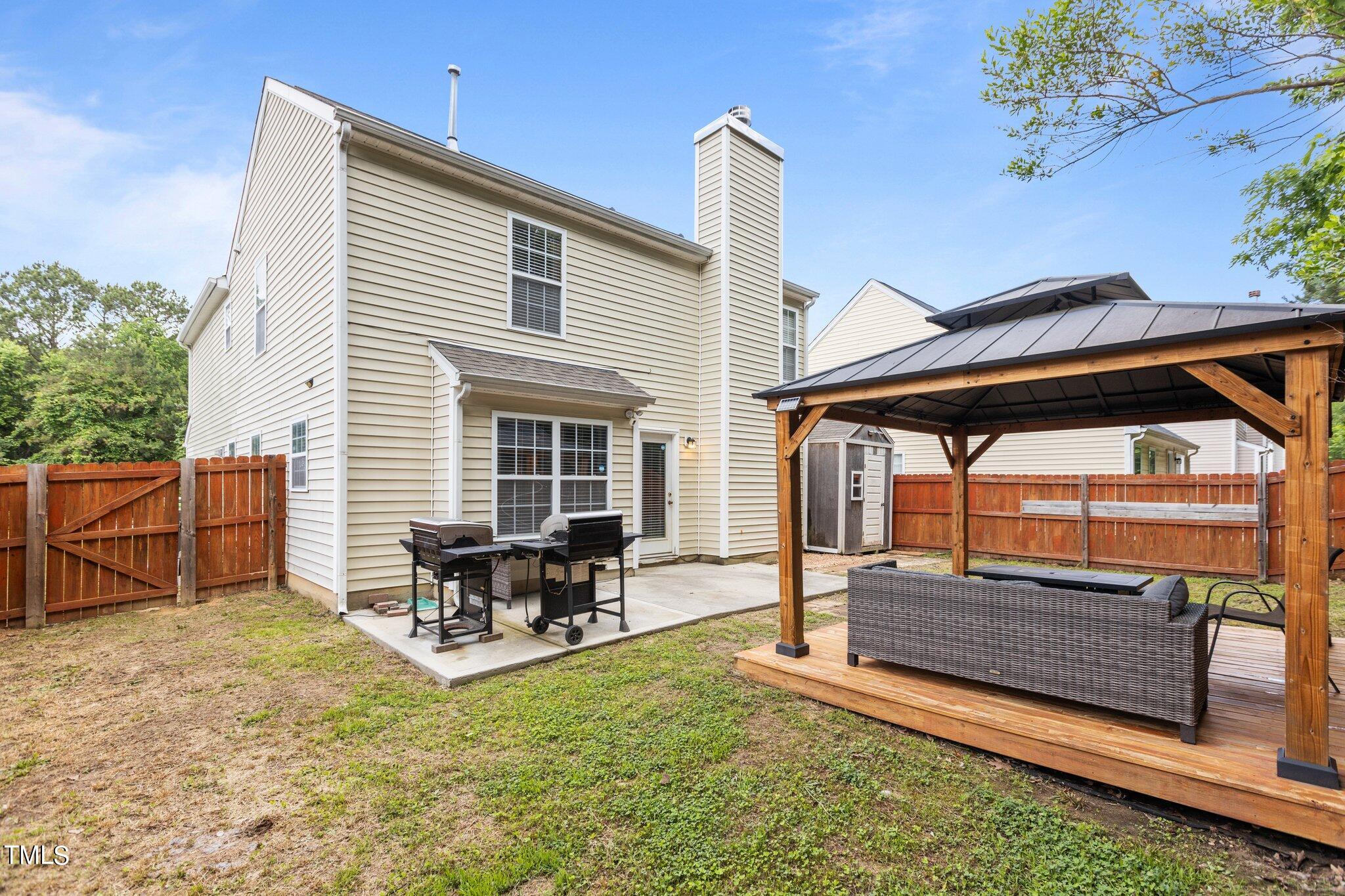 4232 Dalcross Road Raleigh, NC 27610 - Photo 33 of 38 a backyard of a house with table and chairs