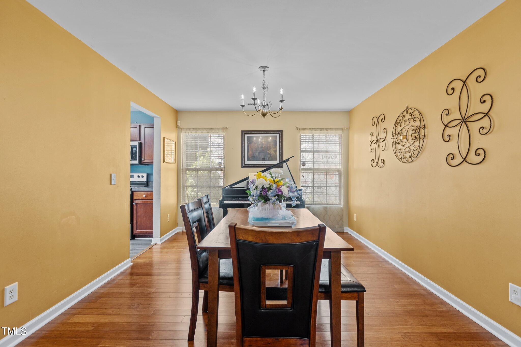4232 Dalcross Road Raleigh, NC 27610 - Photo 4 of 38 a view of a dining room with furniture and wooden floor