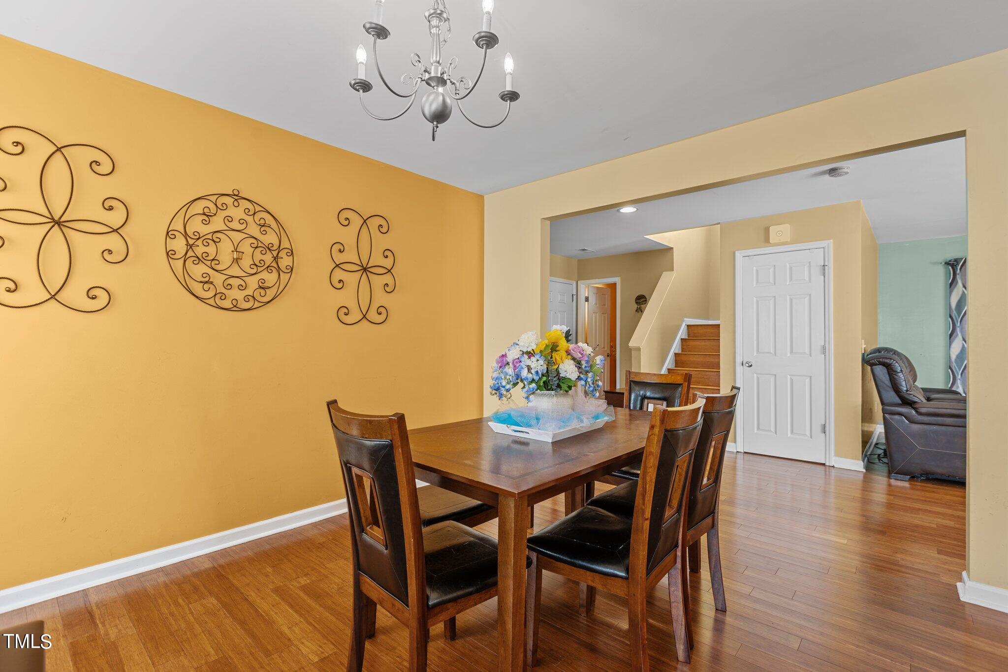 4232 Dalcross Road Raleigh, NC 27610 - Photo 5 of 38 a view of a dining room with furniture and wooden floor