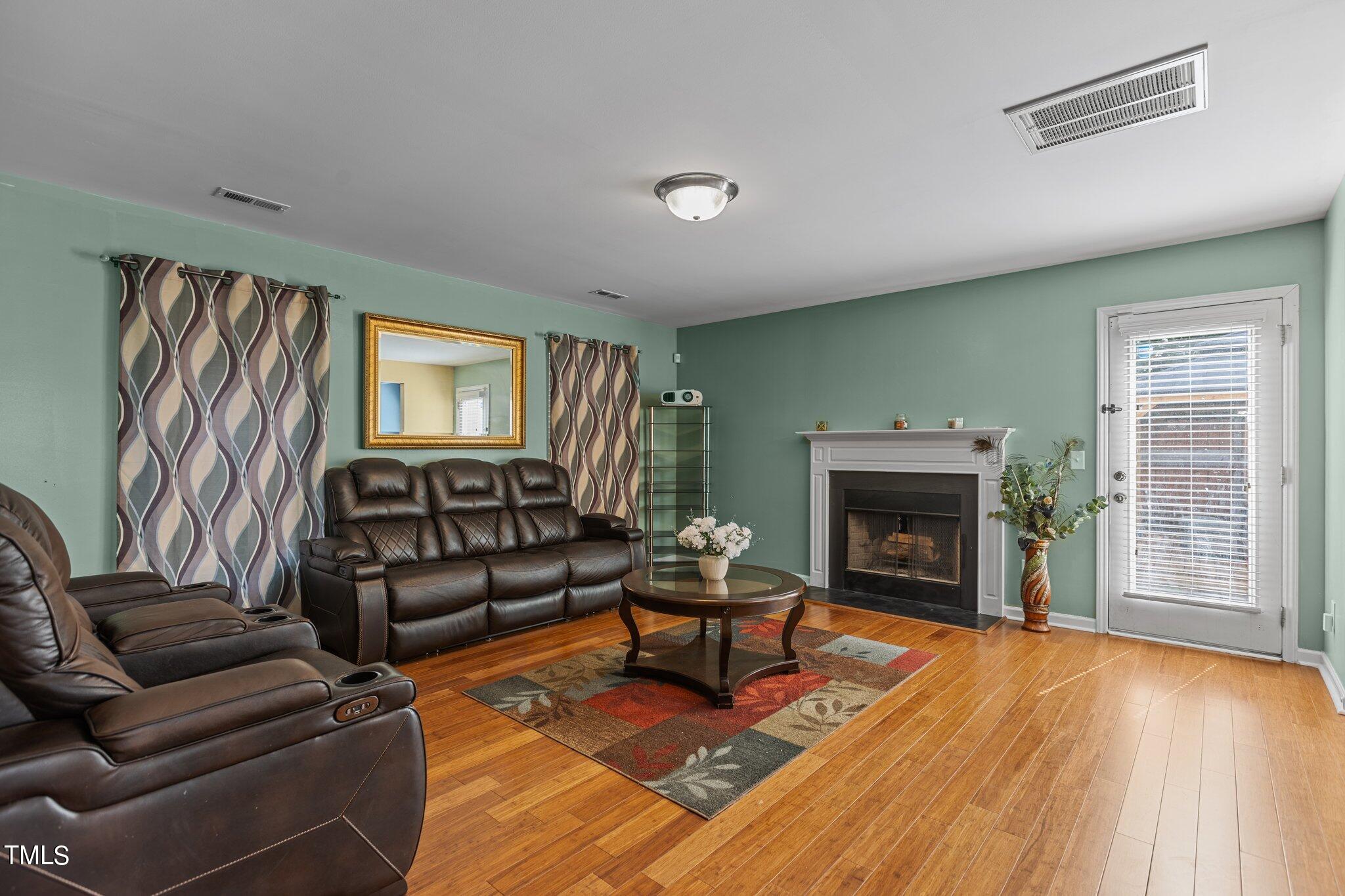 4232 Dalcross Road Raleigh, NC 27610 - Photo 7 of 38 a living room with furniture and a fireplace