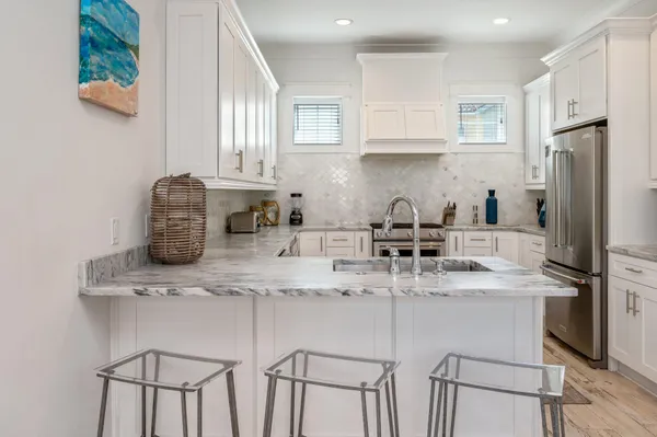 a kitchen with white cabinets and white appliances