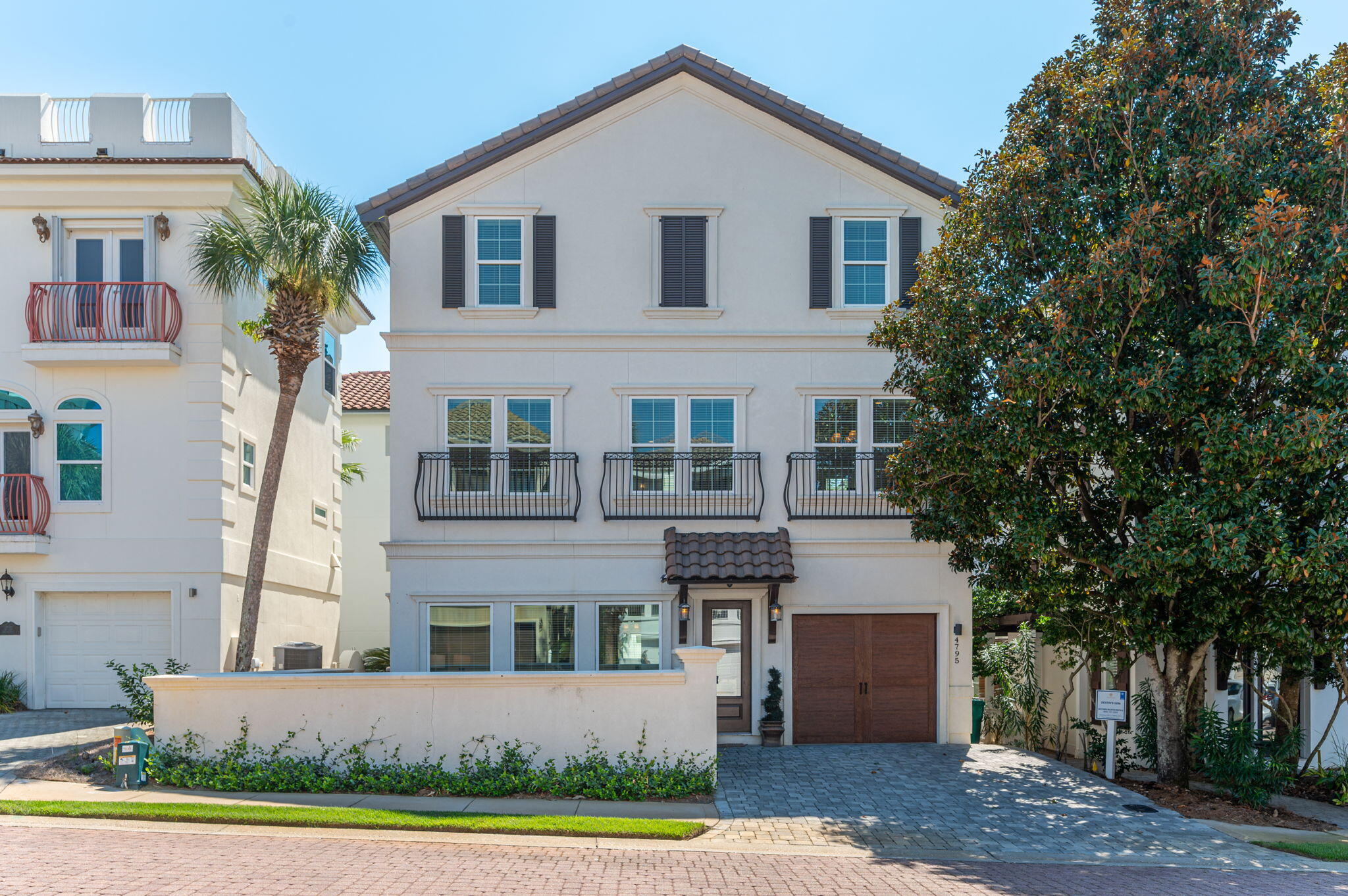 4795 Ocean Boulevard Destin, FL 32541 - Photo 2 of 50 a front view of a house with a yard and garage
