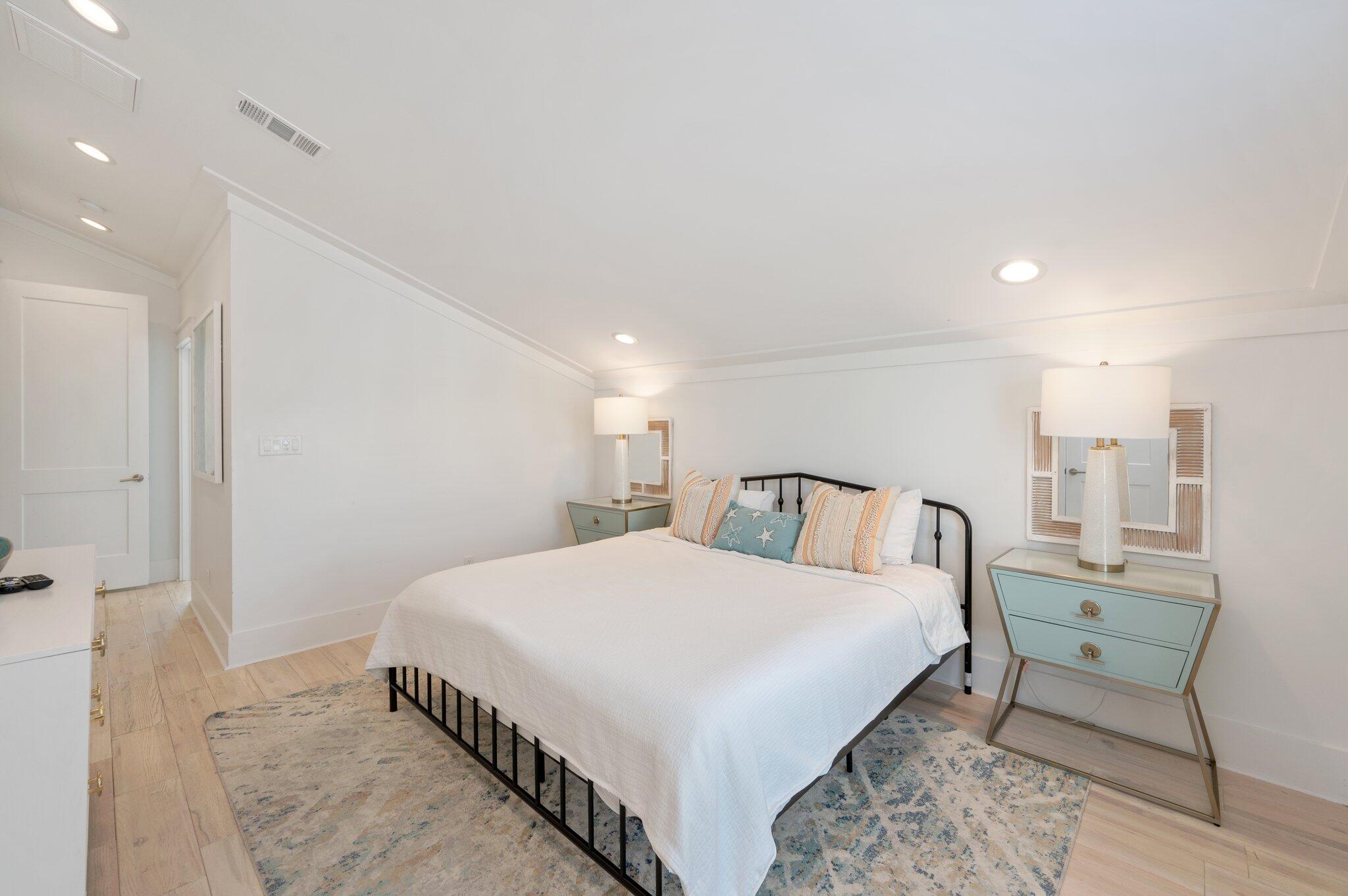 4795 Ocean Boulevard Destin, FL 32541 - Photo 28 of 50 a large bedroom with a bed and a table in it