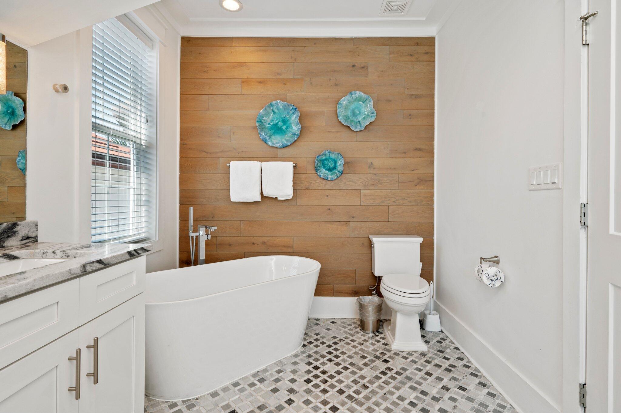 4795 Ocean Boulevard Destin, FL 32541 - Photo 29 of 50 a bathroom with a sink a toilet and a shower curtain