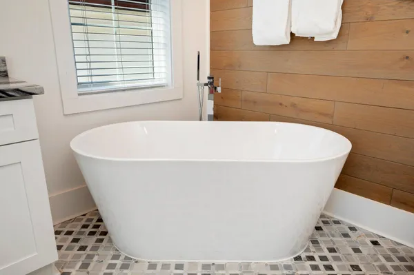 a bathroom with double sink and a mirror