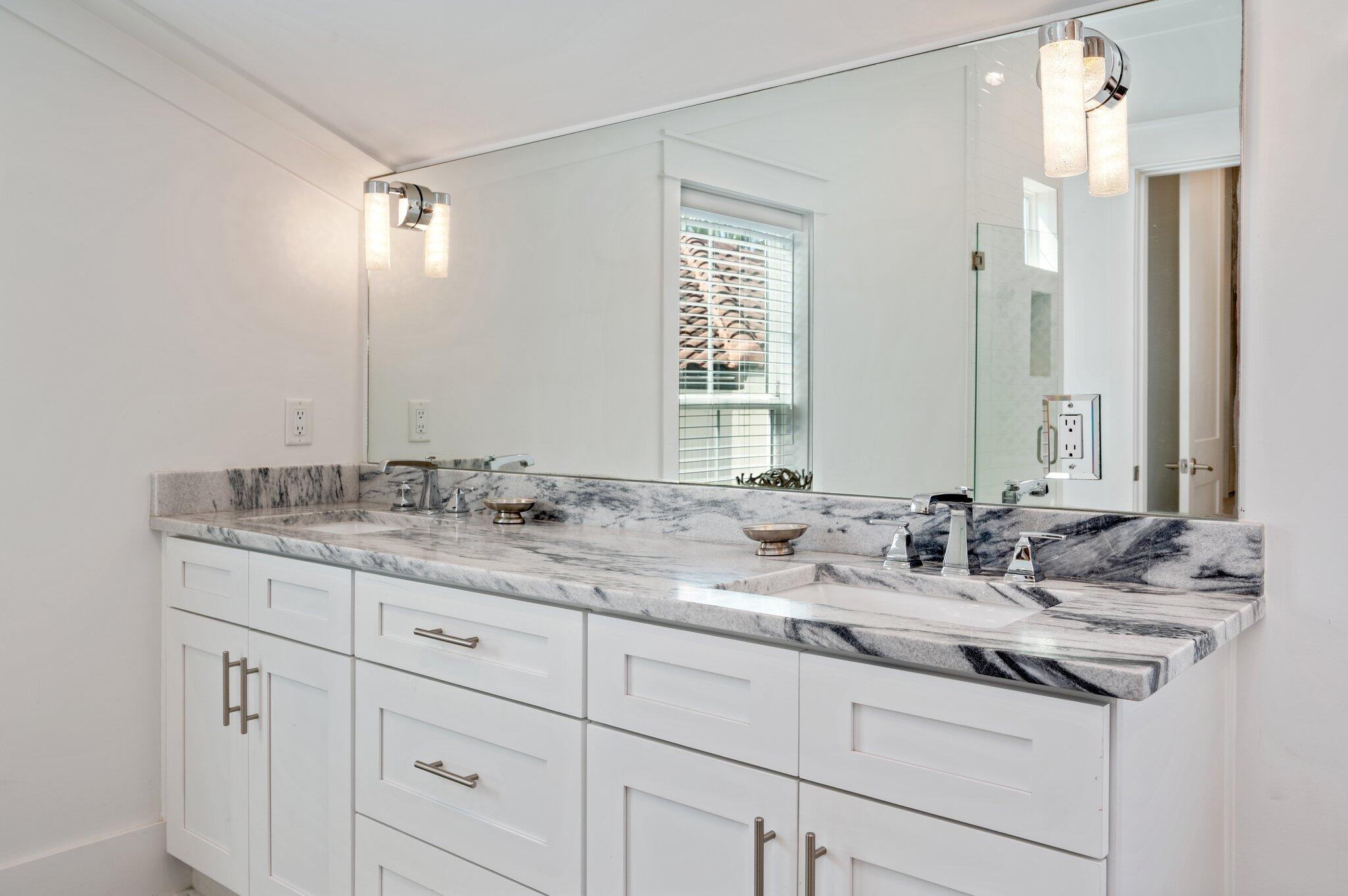 4795 Ocean Boulevard Destin, FL 32541 - Photo 31 of 50 a bathroom with double sink and a mirror