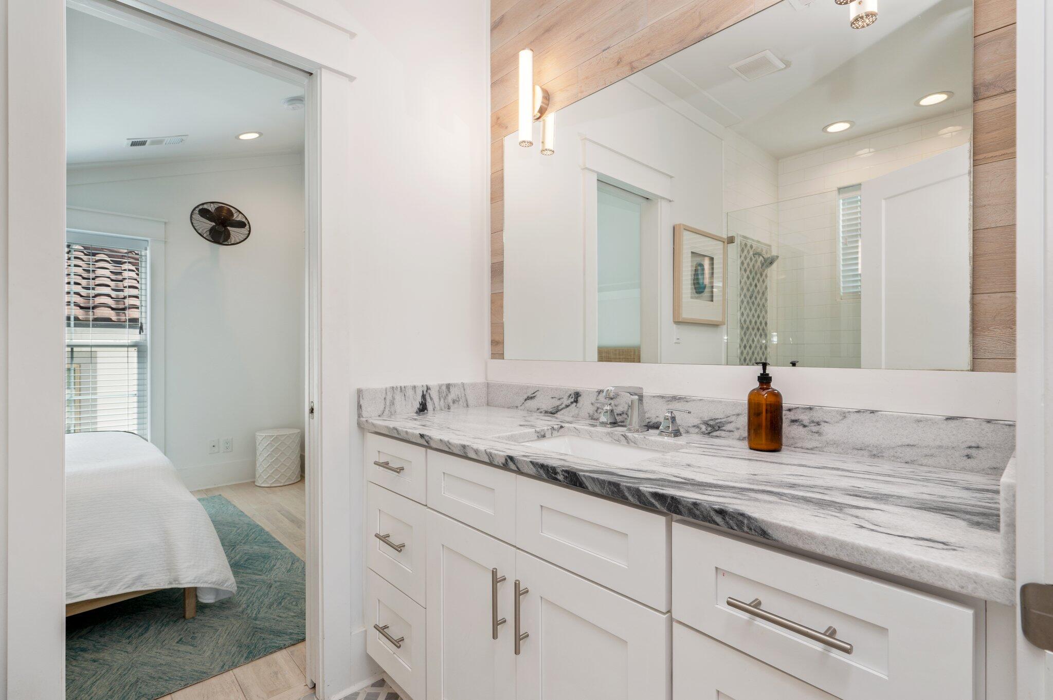 4795 Ocean Boulevard Destin, FL 32541 - Photo 36 of 50 a en suite bathroom with a granite countertop sink and a mirror