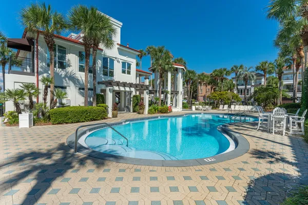 a swimming pool with outdoor seating and yard