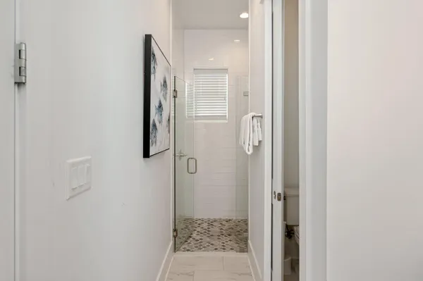 a bathroom with a glass door shower