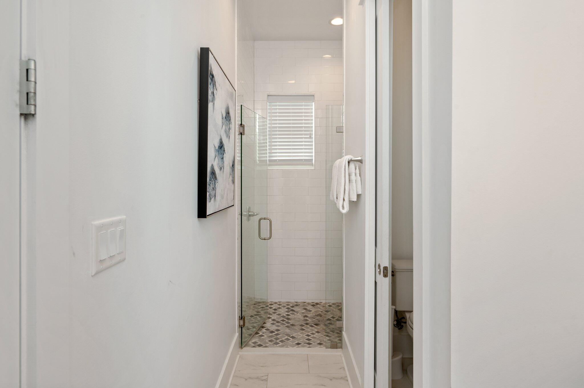 4795 Ocean Boulevard Destin, FL 32541 - Photo 10 of 50 a bathroom with a glass door shower