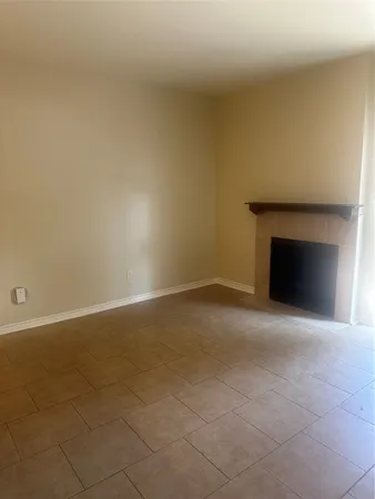 a view of empty room with a fireplace