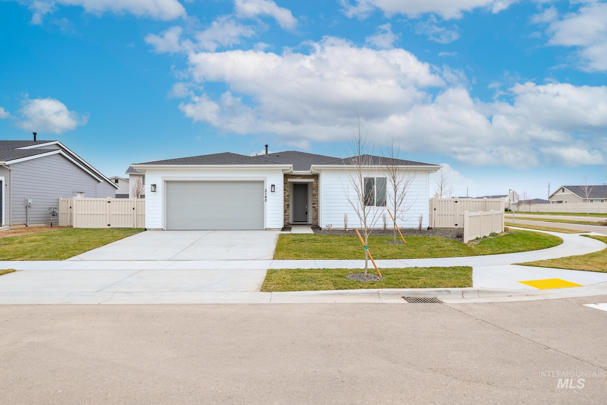 6167 West Snow Currant Street Meridian, ID 83646 - Photo 1 of 12 Contemporary single-story residence with white siding, an attached two-car garage, and a concrete driveway