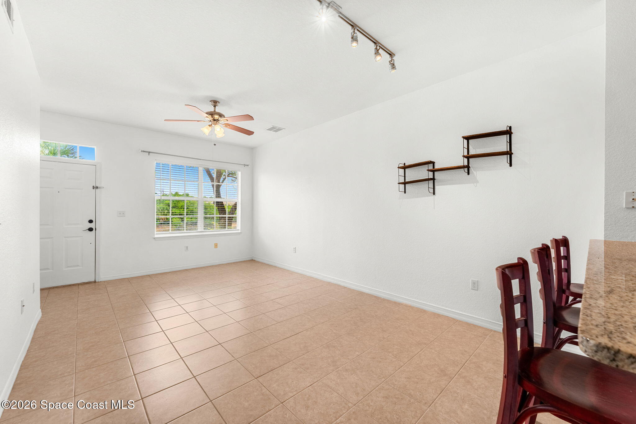 110 Turpial Way, Unit 106 Melbourne, FL 32901 - Photo 12 of 50 a view of a workspace with furniture and a chandelier