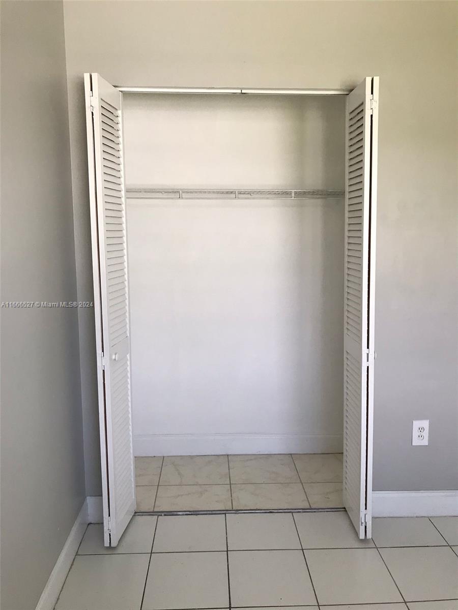 459 Northeast 210th Cir Terrace, Unit 20117 Miami, FL 33179 - Photo 18 of 33 a view of an empty walk in closet