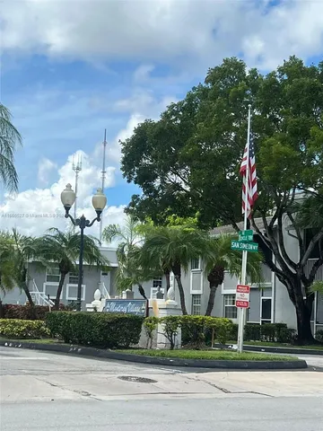 a front view of a house with a tree