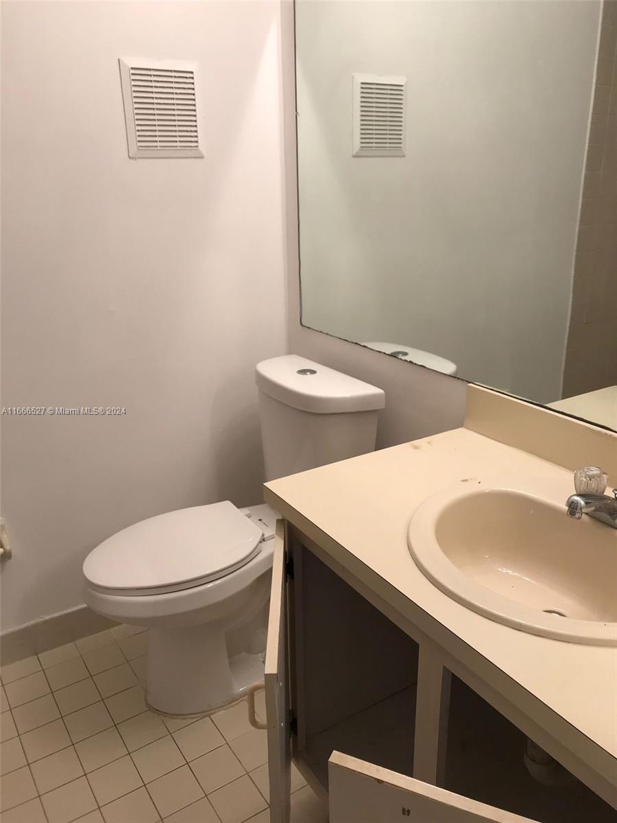 459 Northeast 210th Cir Terrace, Unit 20117 Miami, FL 33179 - Photo 30 of 33 a bathroom with a sink and a toilet