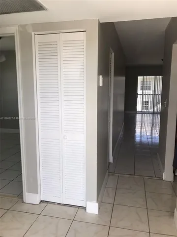 a view of an empty room and a window