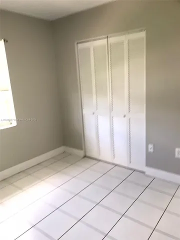 a bathroom with a toilet sink a mirror a bathtub and shower