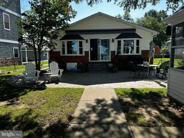 a view of a house with backyard sitting area and garden