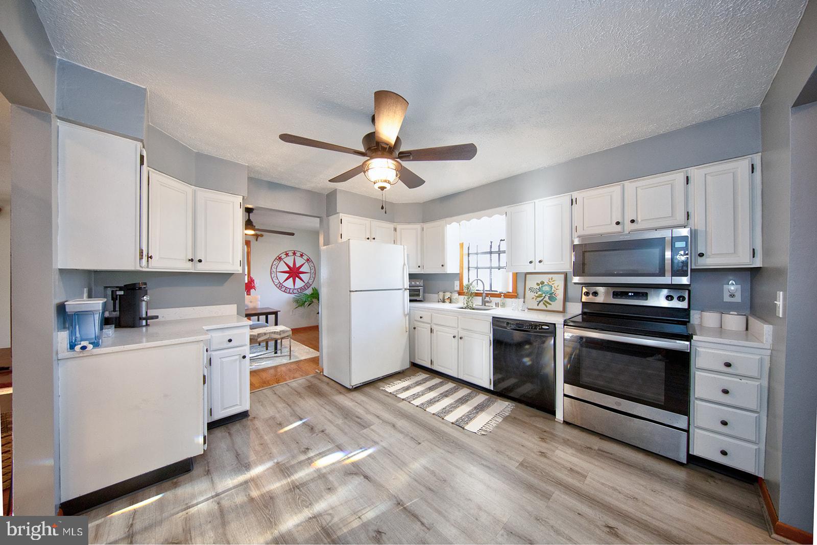 13202 Cherwin Avenue Baltimore, MD 21220 - Photo 17 of 49 a kitchen with granite countertop a sink cabinets and stainless steel appliances
