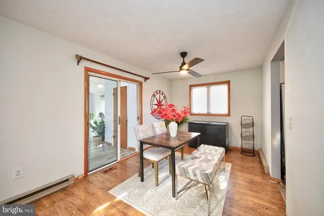 a view of a livingroom with furniture a rug wooden floor and a rug