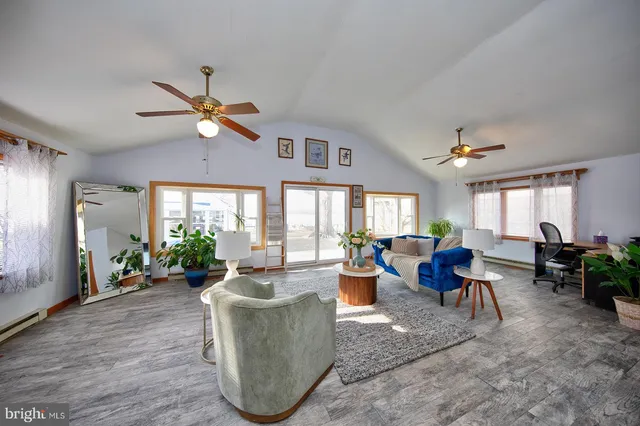 a living room with furniture a chandelier and a large window