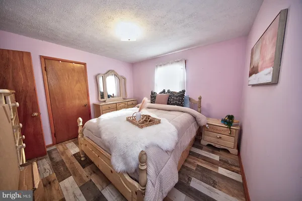 a bedroom with a bed and a closet with mirror