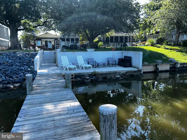 a view of a house with pool and chairs