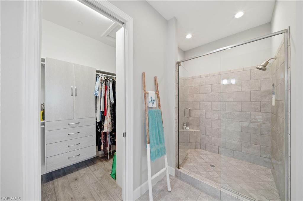 9658 Montelanico Loop, Unit 201 Naples, FL 34119 - Photo 18 of 46 a bathroom with a shower and a tub