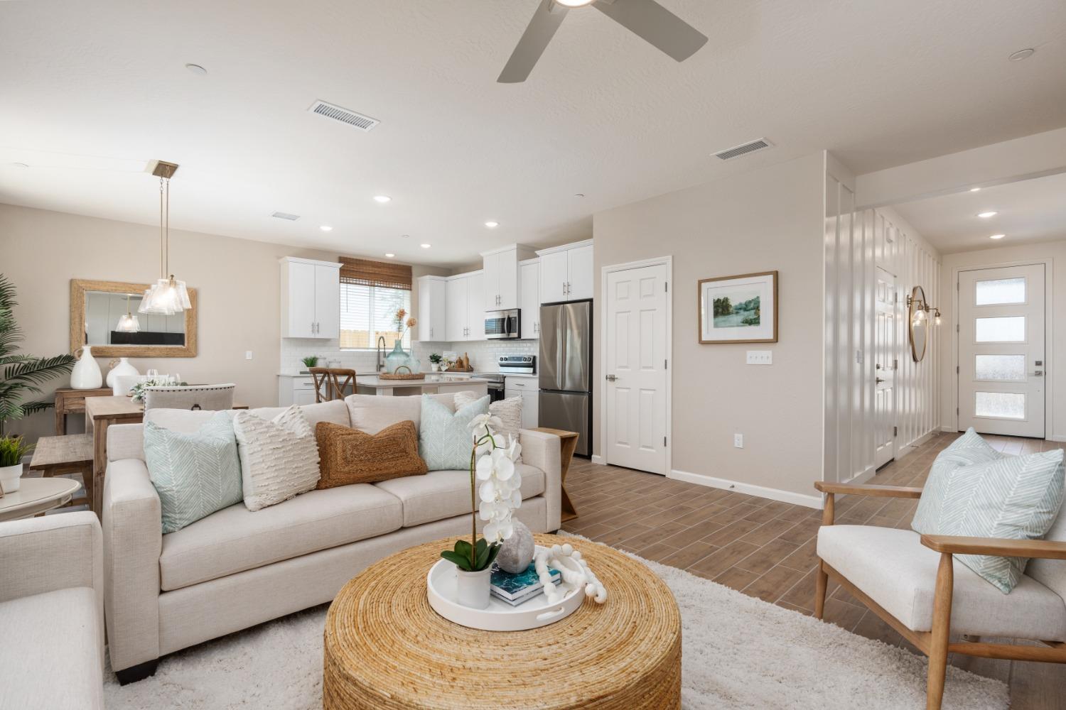 1167 Elevations Way West Madera, CA 93636 - Photo 6 of 28 a living room with furniture and a dining table with kitchen view
