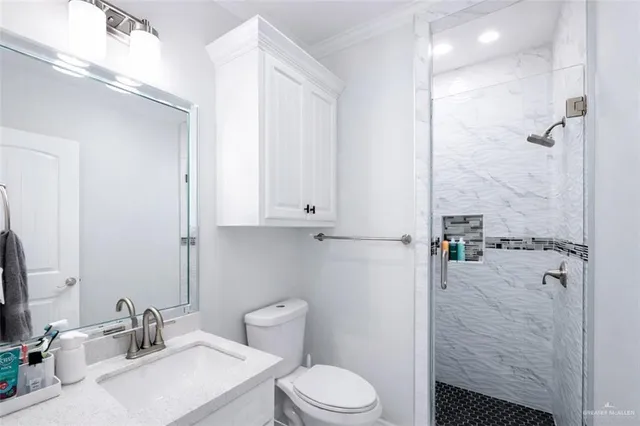 a bathroom with a sink toilet and shower