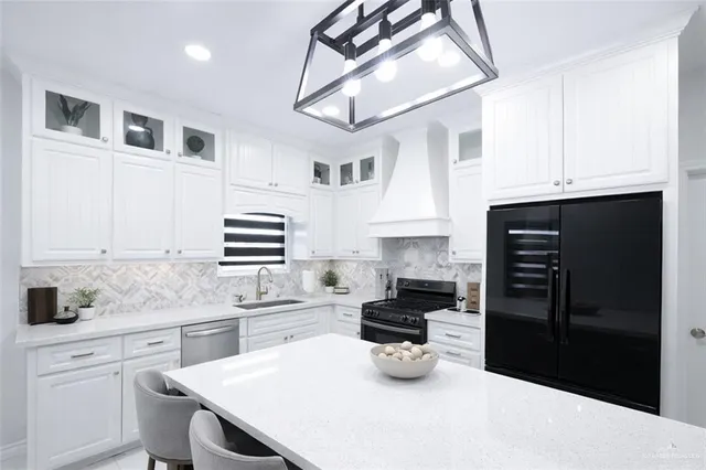 a kitchen with a sink a stove and refrigerator